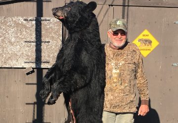 Man Holding Hunted Bear