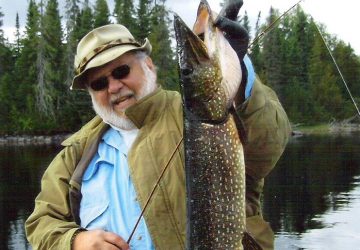 Man Holding Northern Pike Fish