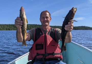 Man Holding Two Walleye