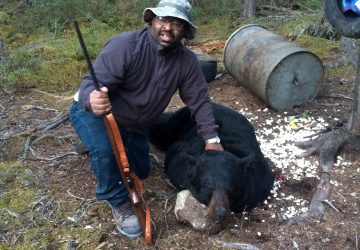 Man With Rifle And Hunted Bear